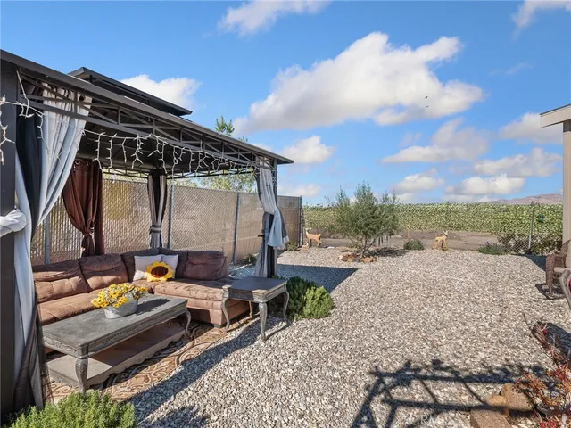 a backyard of a house with outdoor seating