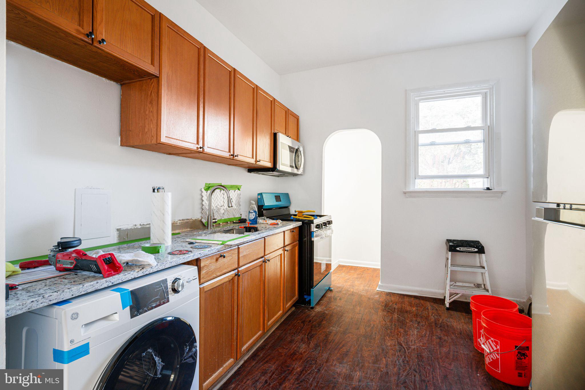 417 South 16th Street, Unit 2 Philadelphia, PA 19146 - Photo 4 of 10 a kitchen with stainless steel appliances granite countertop a sink dishwasher stove refrigerator and cabinets