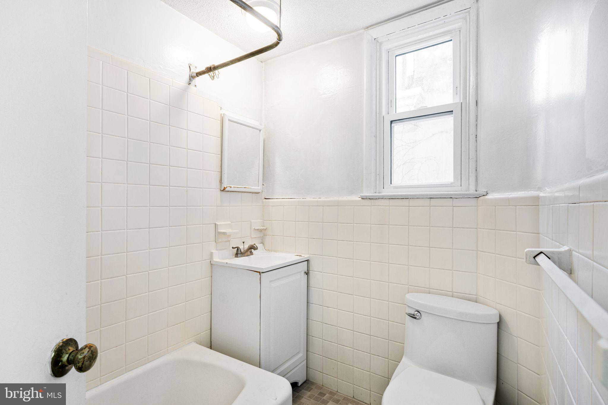 417 South 16th Street, Unit 2 Philadelphia, PA 19146 - Photo 6 of 10 a bathroom with a toilet sink and mirror