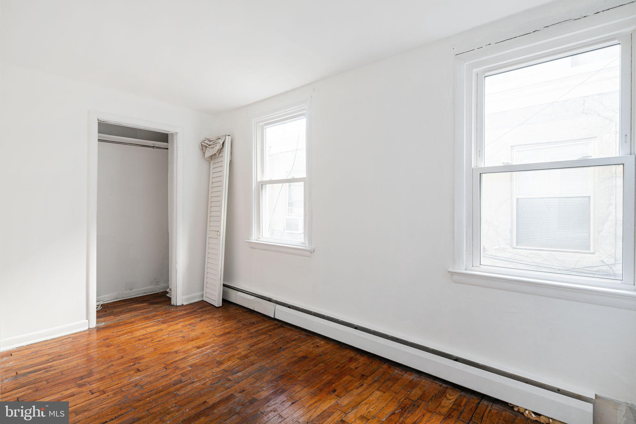 417 South 16th Street, Unit 2 Philadelphia, PA 19146 - Photo 8 of 10 an empty room with wooden floor and windows