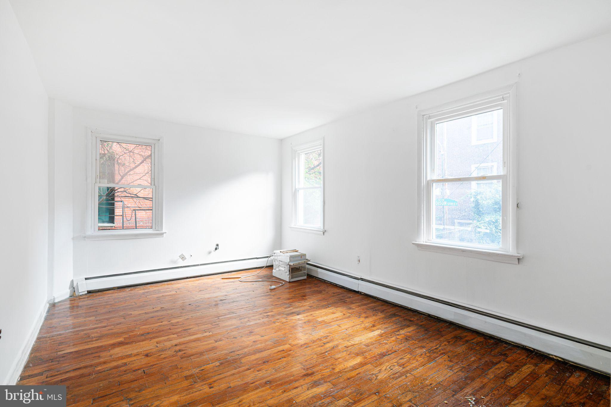 417 South 16th Street, Unit 2 Philadelphia, PA 19146 - Photo 9 of 10 an empty room with wooden floor and windows