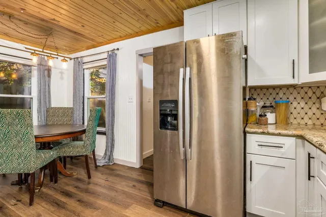 a kitchen with stainless steel appliances a refrigerator and wooden cabinets