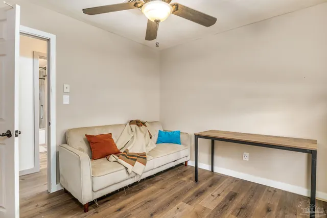 a living room with furniture and a ceiling fan