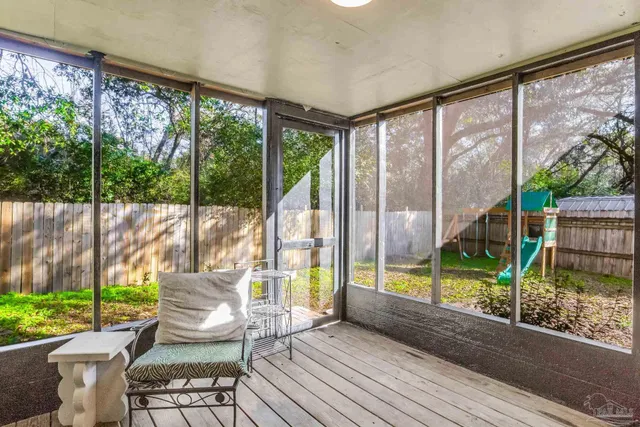 a view of deck with furniture and garden