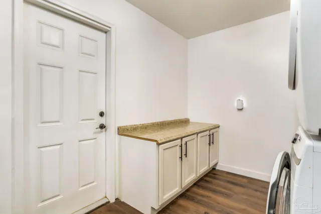 a utility room with wooden floor