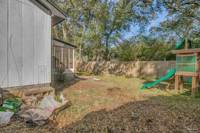 a view of backyard with a slide