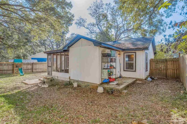 a backyard of a house with table and chairs