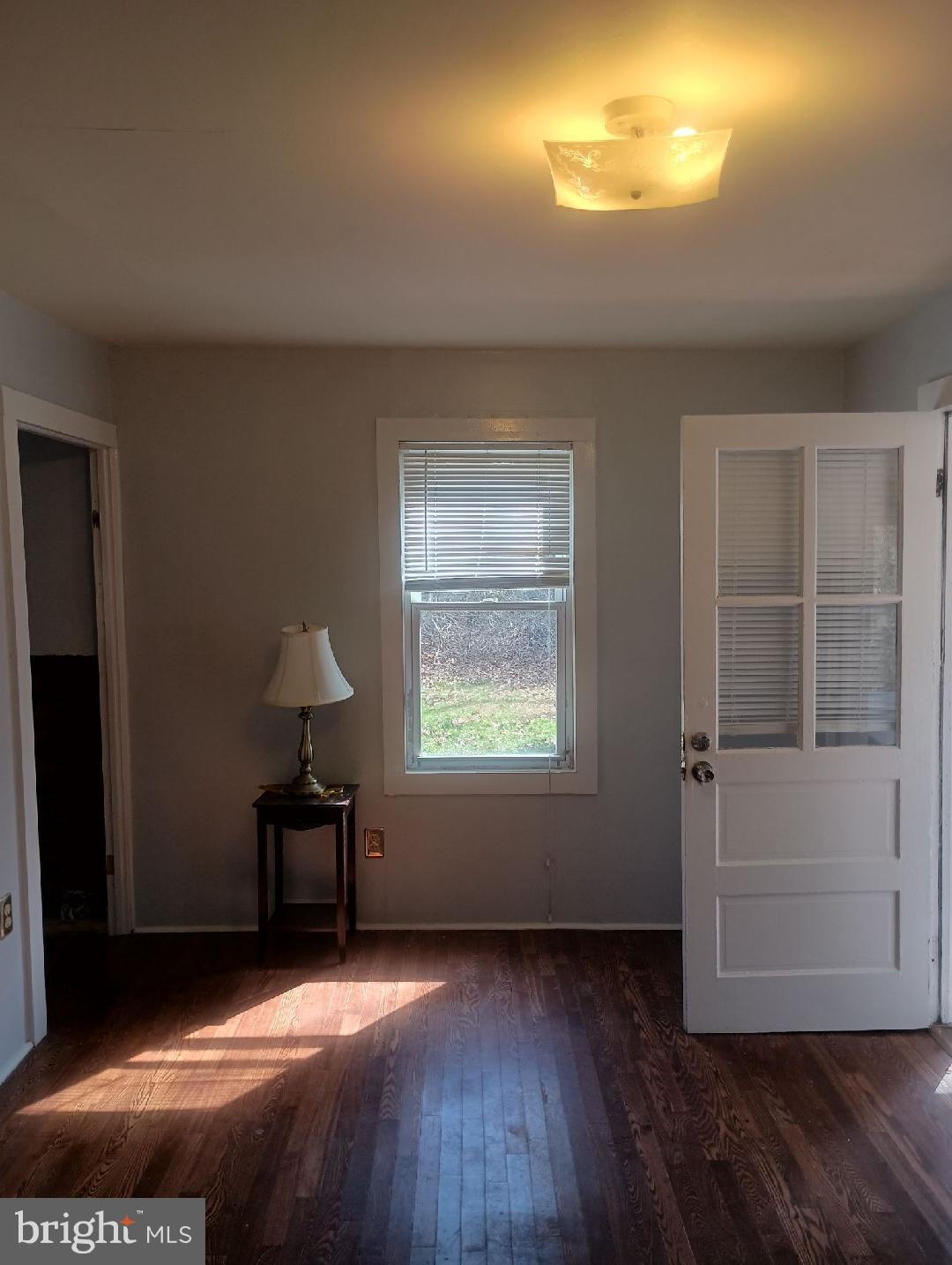 138 Jute Road Millville, NJ 08332 - Photo 5 of 12 a view of an empty room with wooden floor and a window