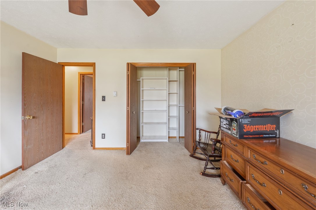4790 Paradise Road Seville, OH 44273 - Photo 33 of 45 Bedroom featuring baseboards, a ceiling fan, and light colored carpet