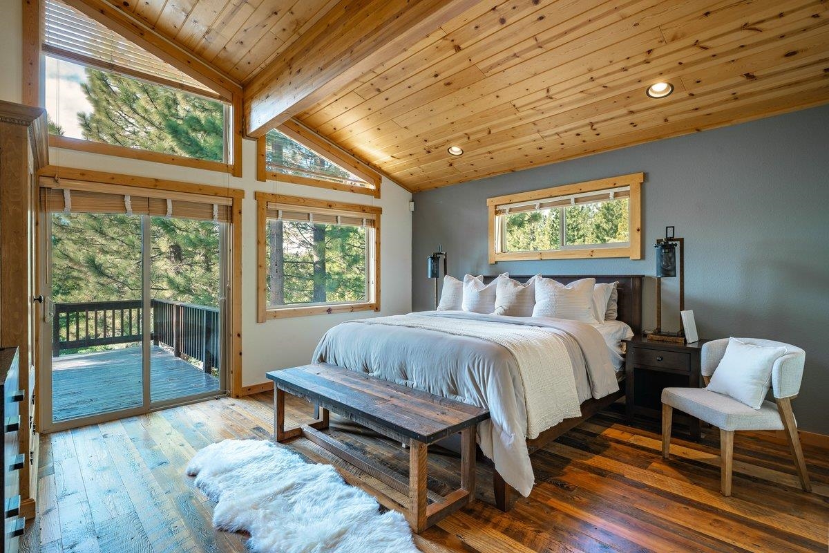 12391 Stockholm Way Truckee, CA 96161 - Photo 15 of 28 a spacious bedroom with a bed and a large window