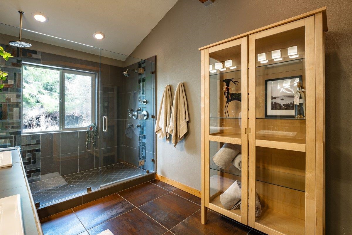 12391 Stockholm Way Truckee, CA 96161 - Photo 17 of 28 a bathroom with a glass shower door and a window
