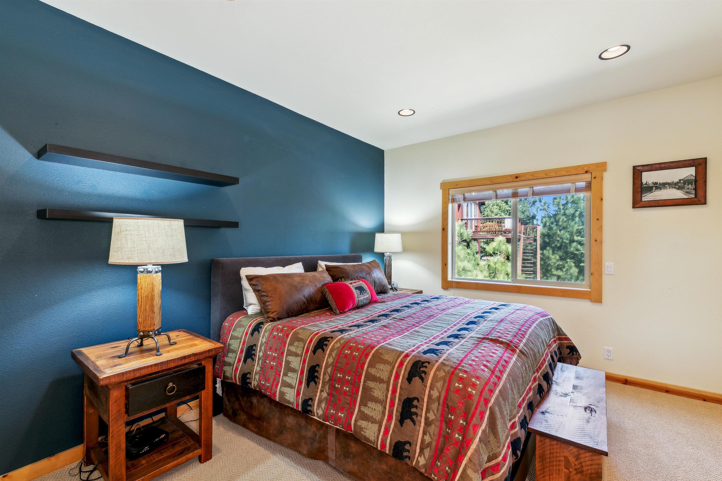 12391 Stockholm Way Truckee, CA 96161 - Photo 20 of 28 a bedroom with a bed and a lamp