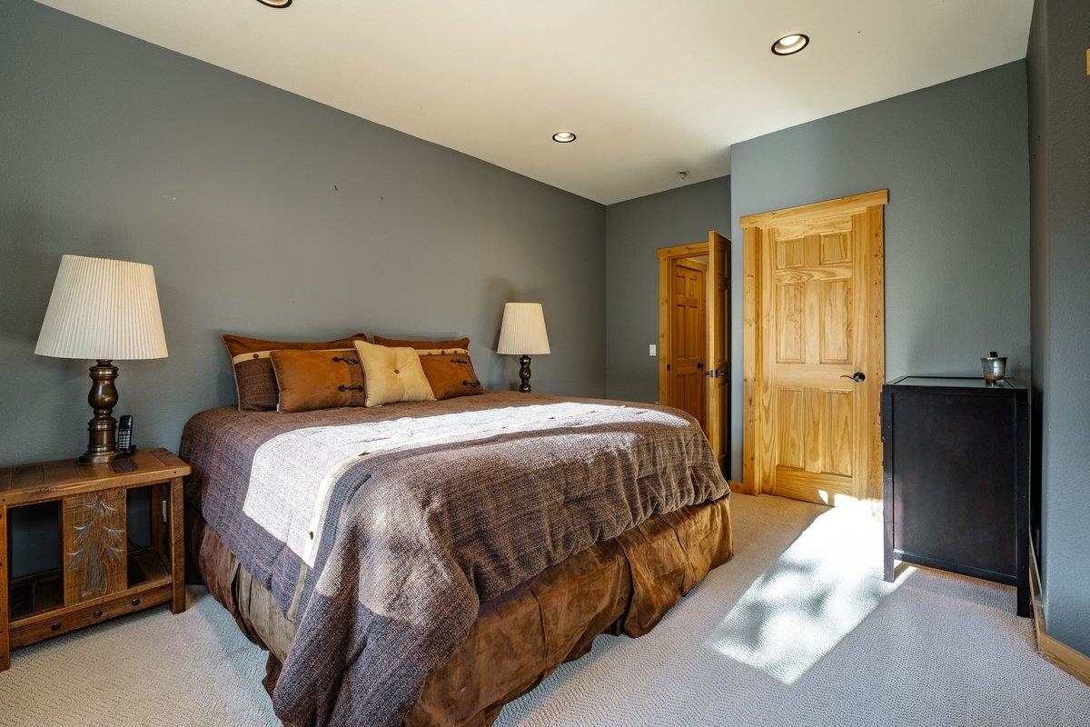 12391 Stockholm Way Truckee, CA 96161 - Photo 23 of 28 a bedroom with a bed and a lamp
