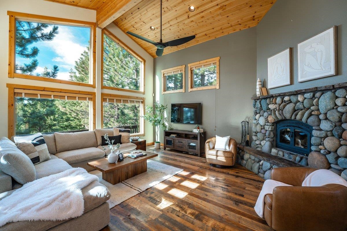 12391 Stockholm Way Truckee, CA 96161 - Photo 7 of 28 a living room with fireplace furniture and a floor to ceiling window