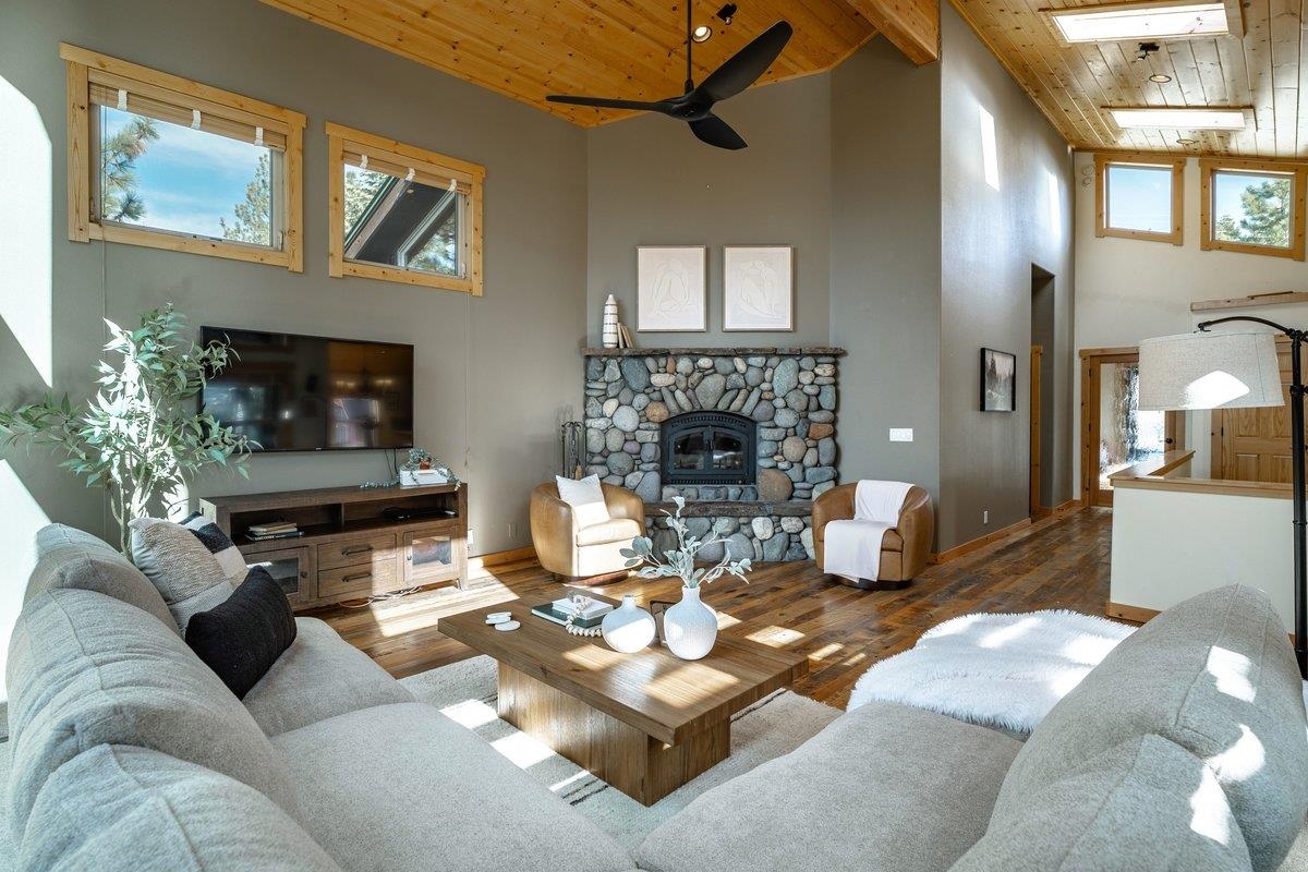 12391 Stockholm Way Truckee, CA 96161 - Photo 8 of 28 a living room with furniture a fireplace and a flat screen tv