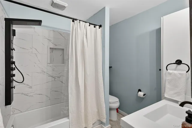 a bathroom with a shower curtain and a sink