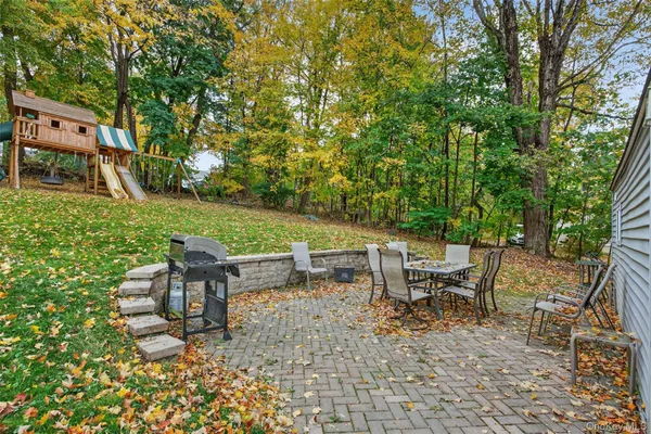 a backyard of a house with table and chairs