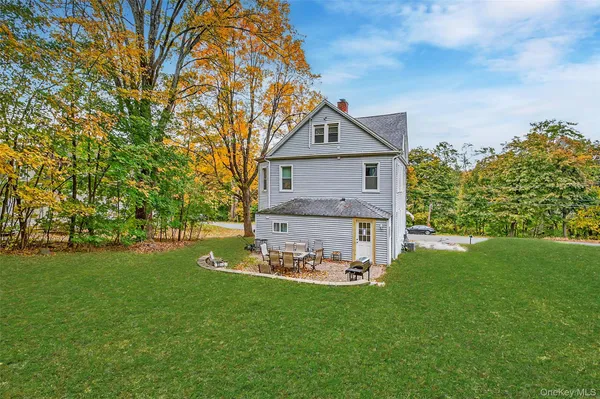 a front view of a house with a garden and yard