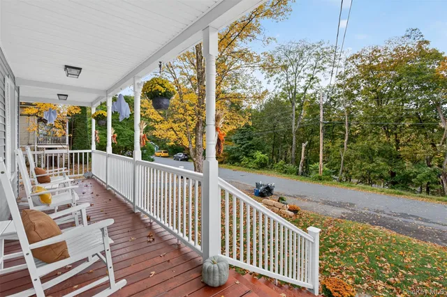 a view of balcony with wooden floor and fence