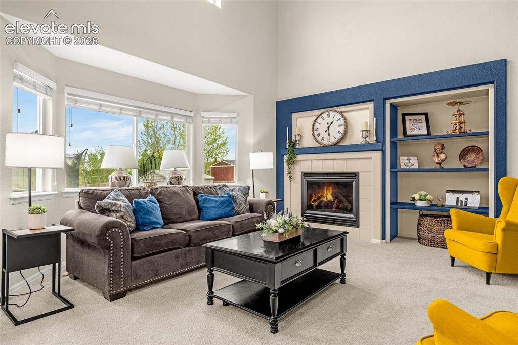 9127 Oakmont Road Peyton, CO 80831 - Photo 12 of 49 a living room with furniture and a fireplace