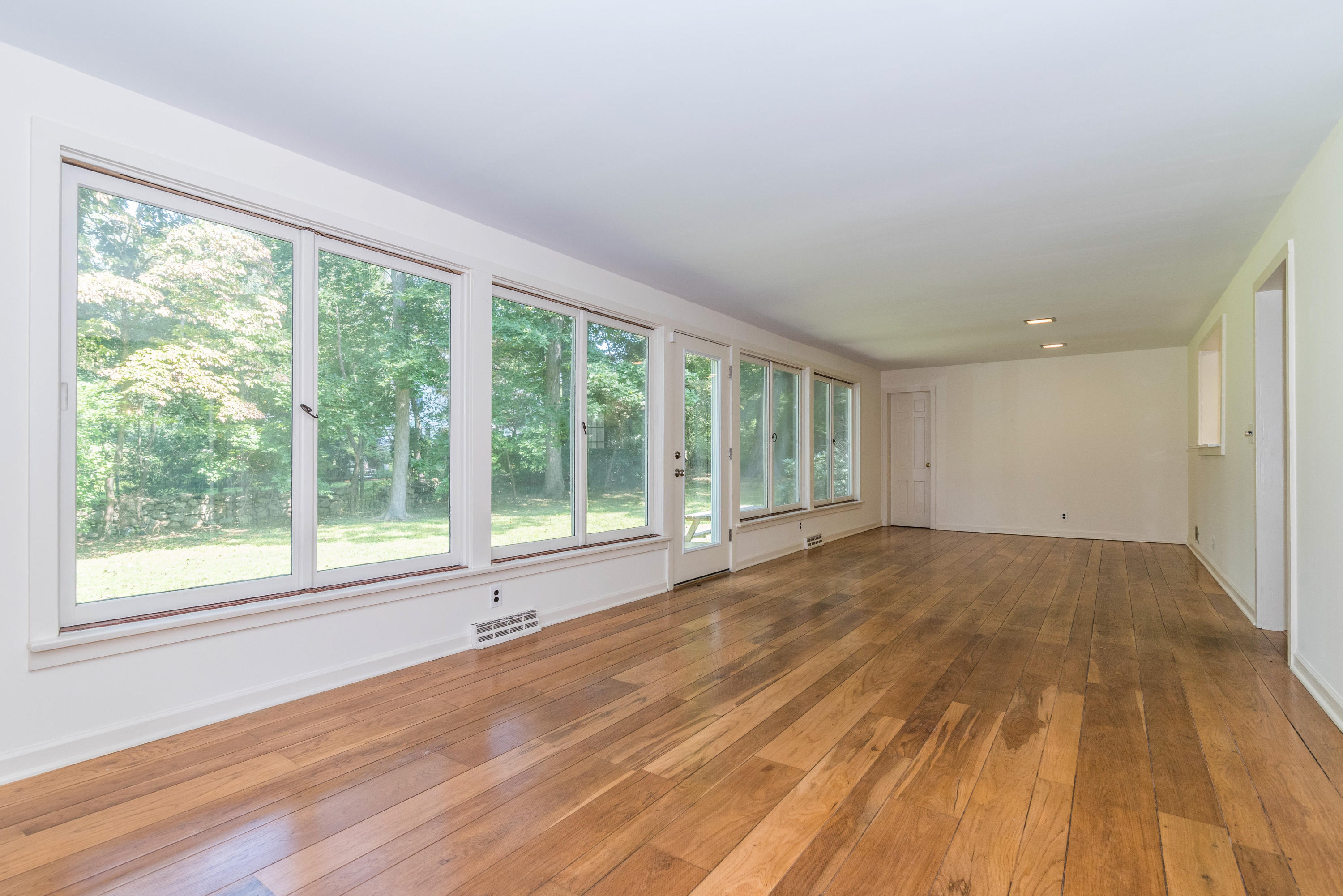 10 Rocaton Road Darien, CT 06820 - Photo 13 of 24 a view of an empty room with wooden floor and a window