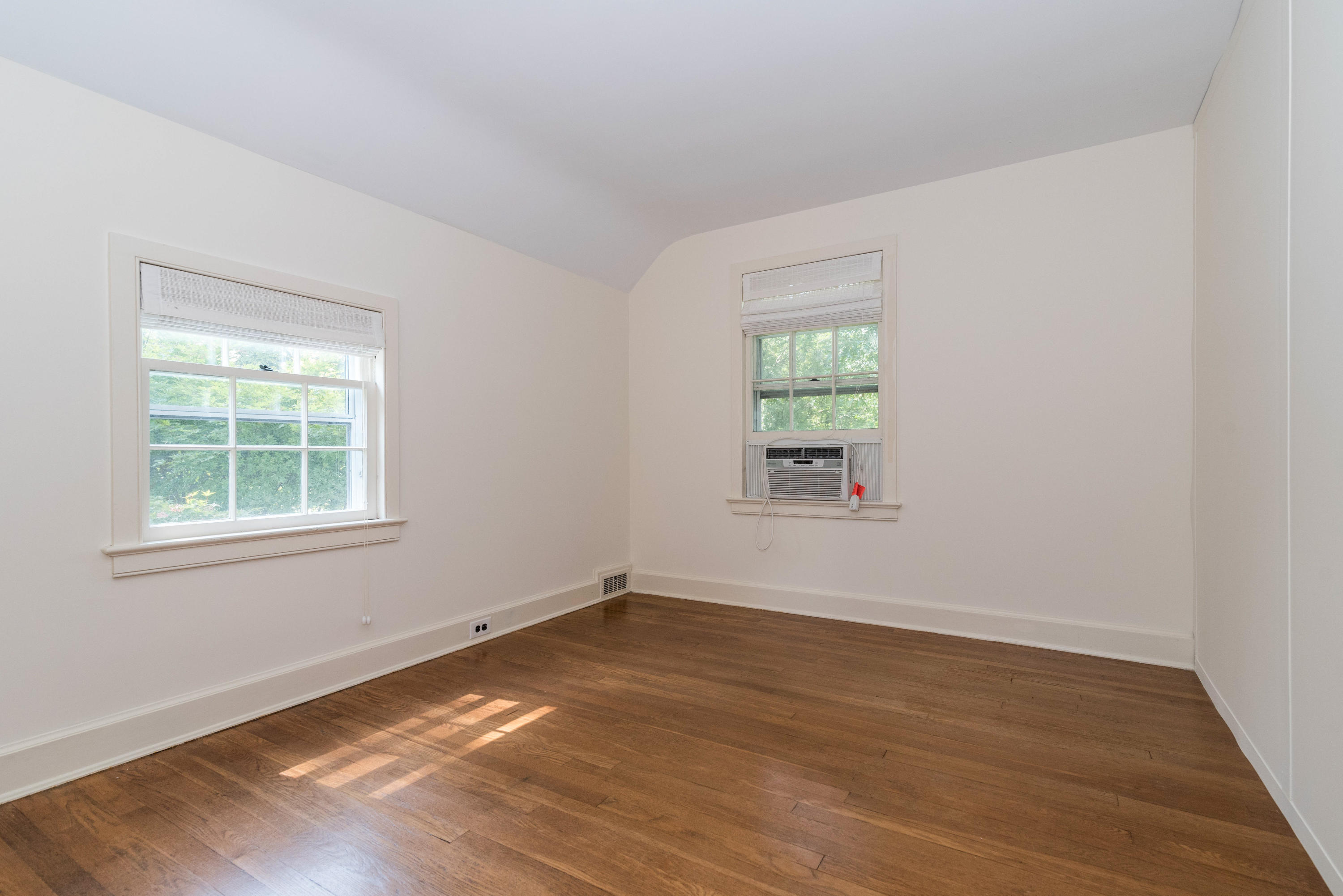 10 Rocaton Road Darien, CT 06820 - Photo 14 of 24 an empty room with wooden floor and windows