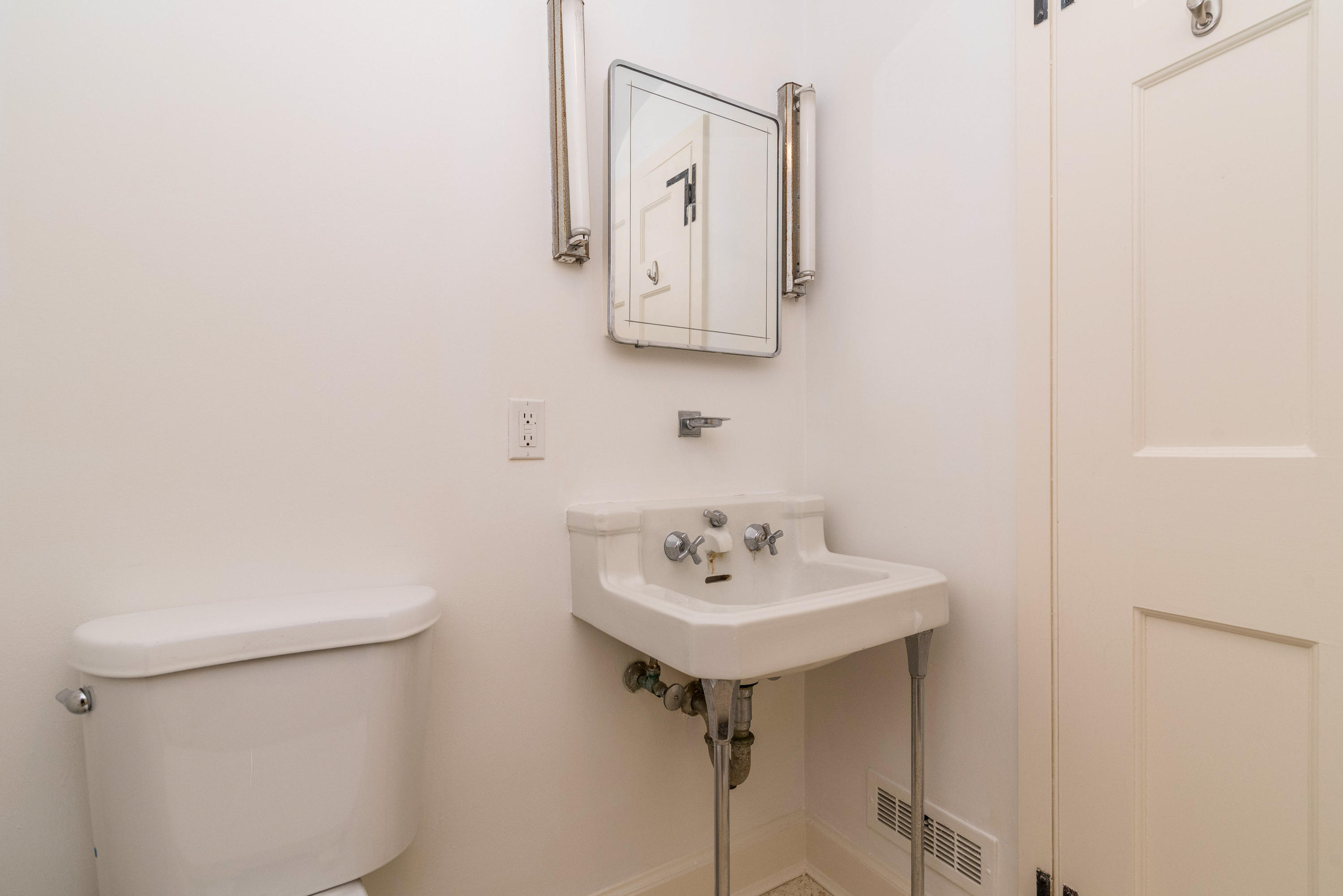 10 Rocaton Road Darien, CT 06820 - Photo 18 of 24 a bathroom with a sink a toilet and mirror
