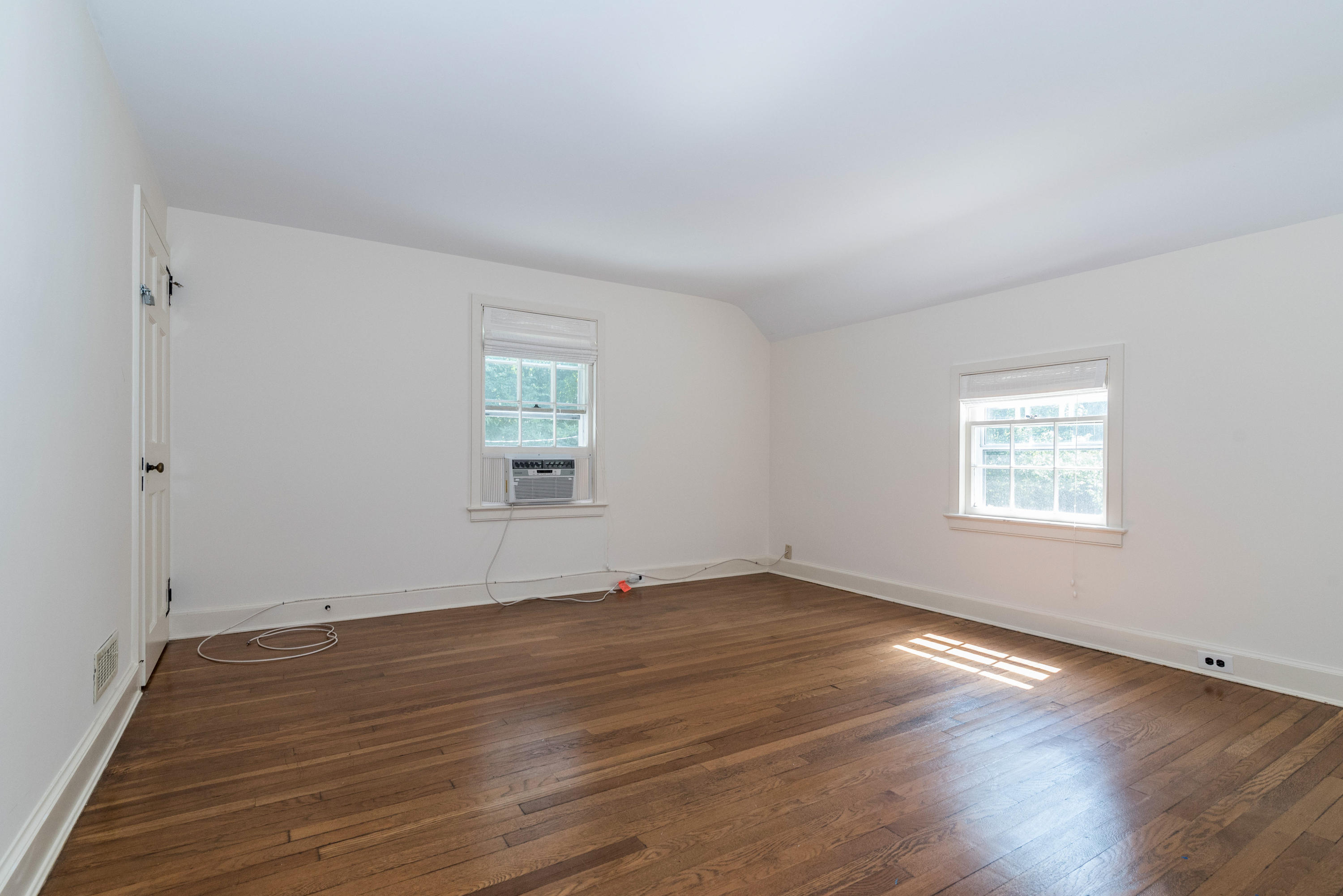10 Rocaton Road Darien, CT 06820 - Photo 19 of 24 an empty room with wooden floor and windows