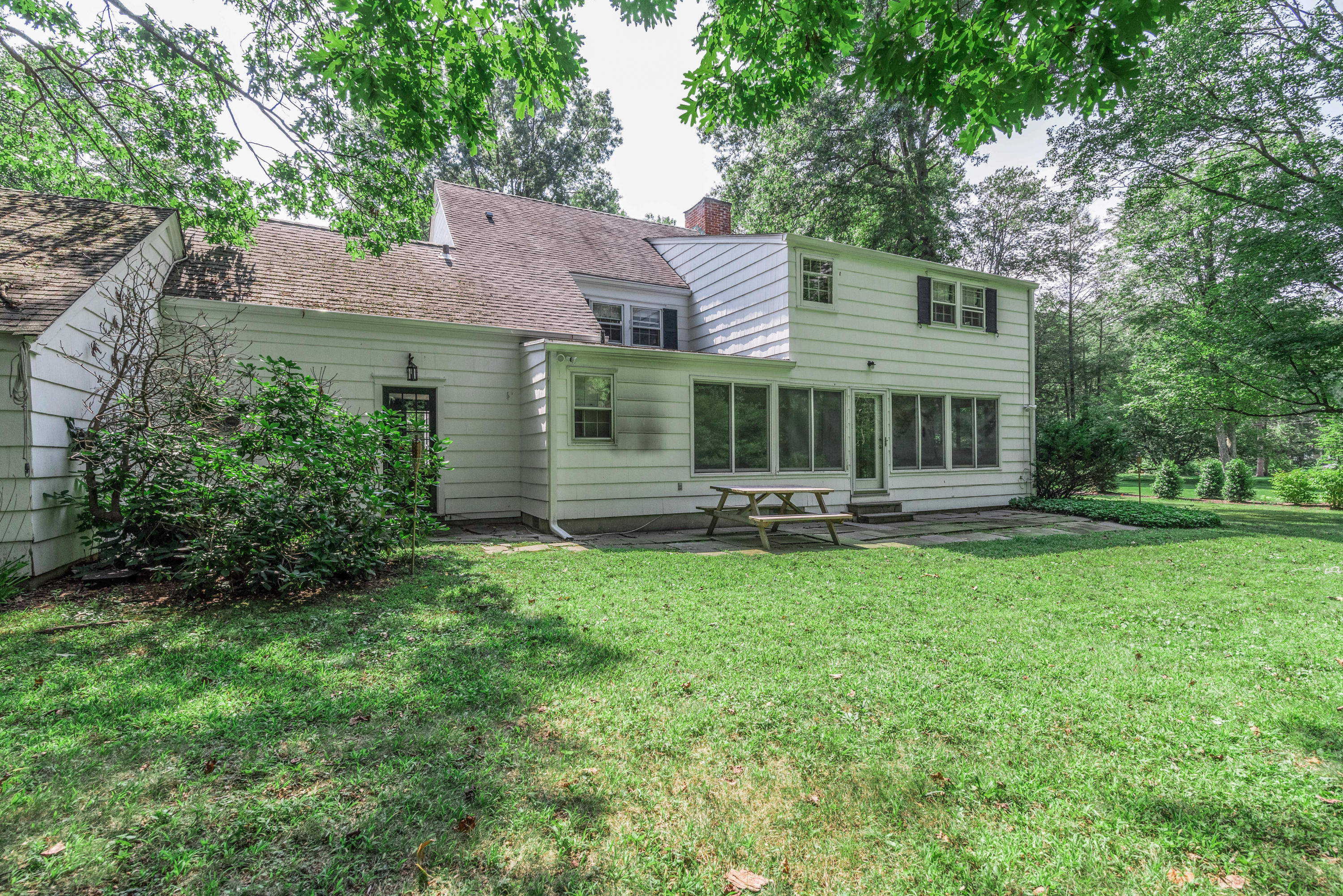 10 Rocaton Road Darien, CT 06820 - Photo 22 of 24 a backyard of a house with yard table and chairs