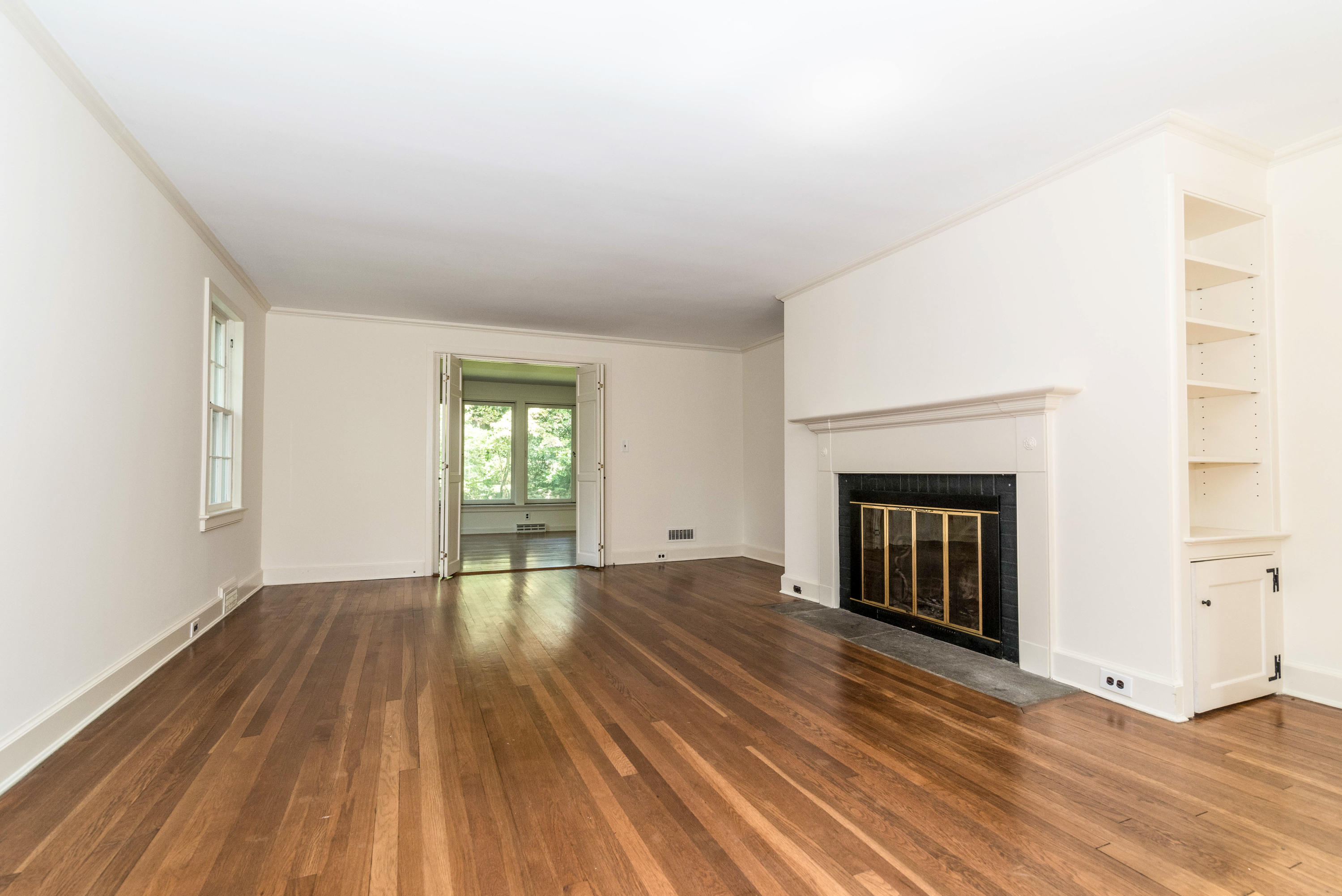 10 Rocaton Road Darien, CT 06820 - Photo 6 of 24 a view of empty room with wooden floor and fireplace