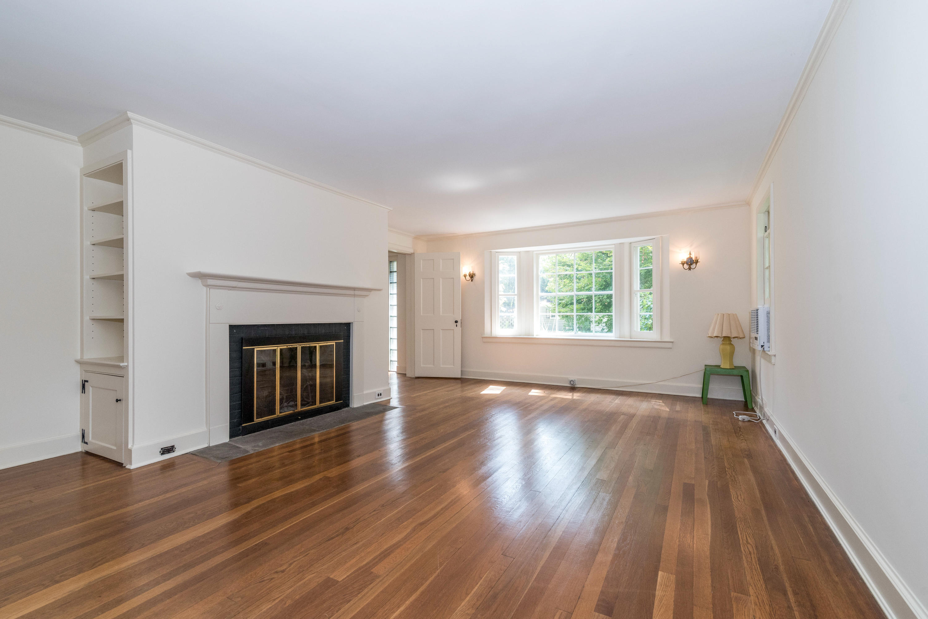 10 Rocaton Road Darien, CT 06820 - Photo 7 of 24 an empty room with wooden floor windows and fireplace