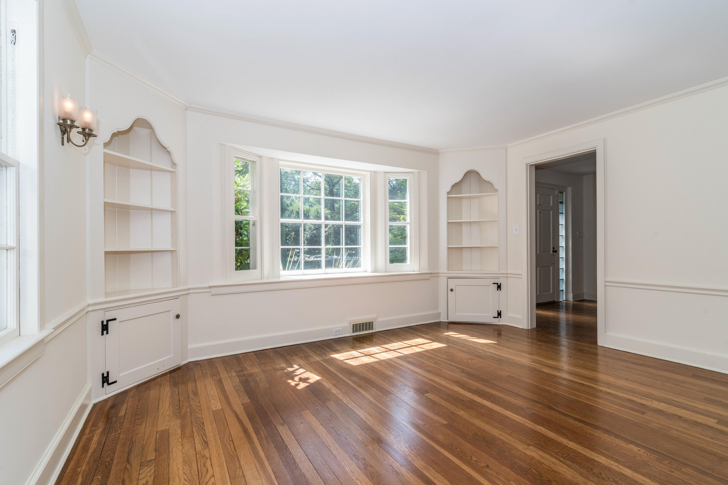 10 Rocaton Road Darien, CT 06820 - Photo 9 of 24 an empty room with wooden floor and windows