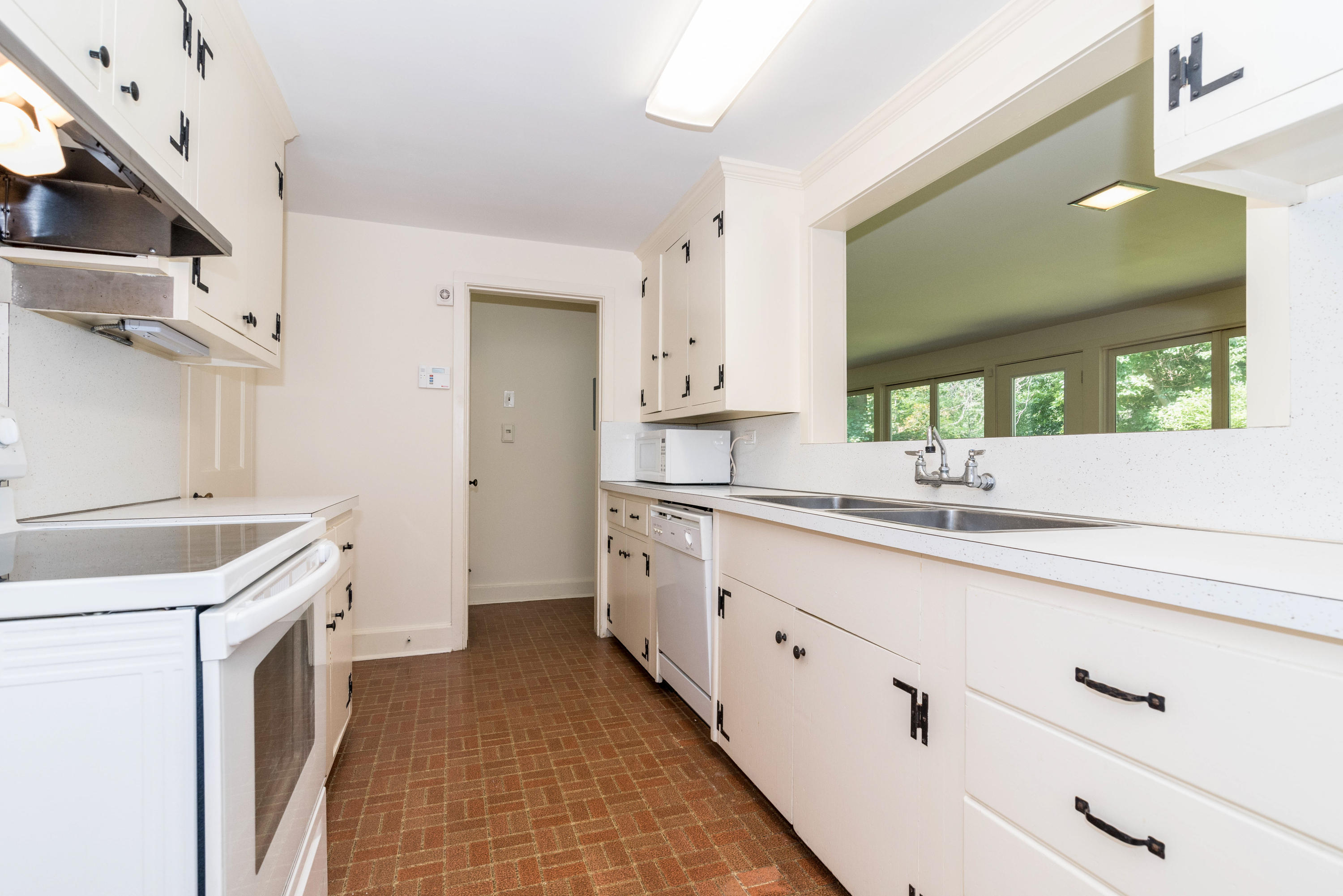 10 Rocaton Road Darien, CT 06820 - Photo 10 of 24 a kitchen with a sink stove and cabinets
