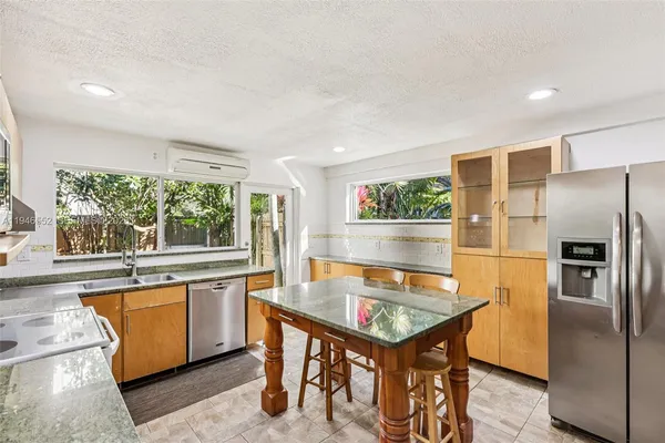 a view of kitchen with wooden floor and seating space