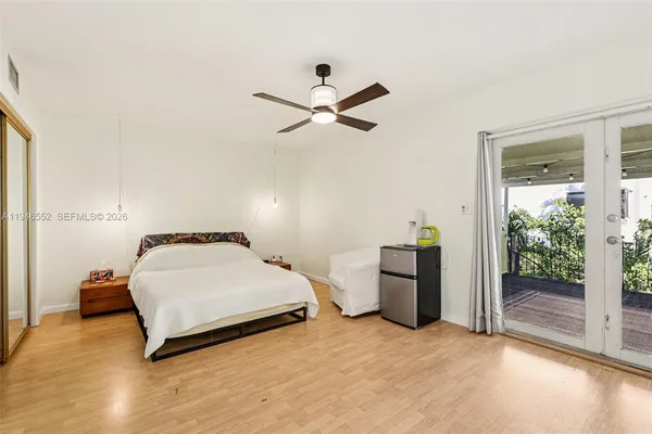 a bedroom with a bed and a ceiling fan