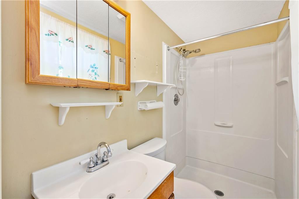 157 Valley View Road Eighty Four, PA 15330 - Photo 15 of 25 a bathroom with a sink a mirror and a shower
