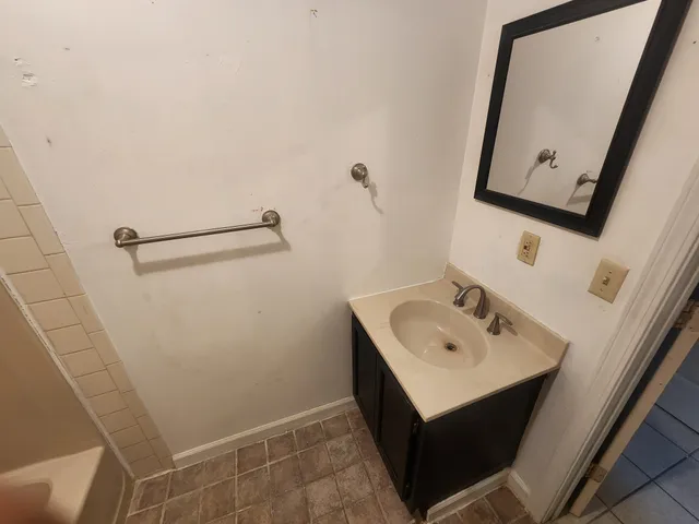 a bathroom with a sink a mirror and vanity