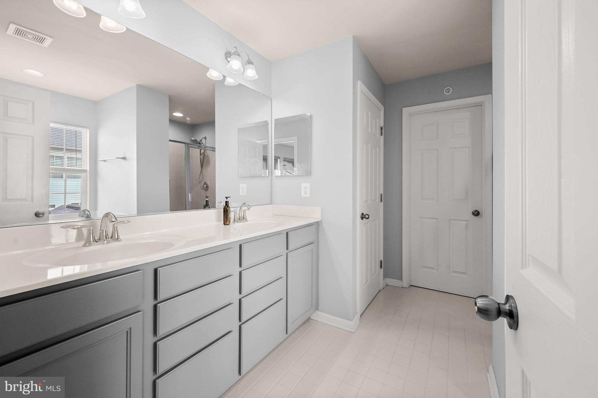 3515 Doc Berlin Drive Silver Spring, MD 20906 - Photo 20 of 49 a bathroom with a double vanity sink mirror and