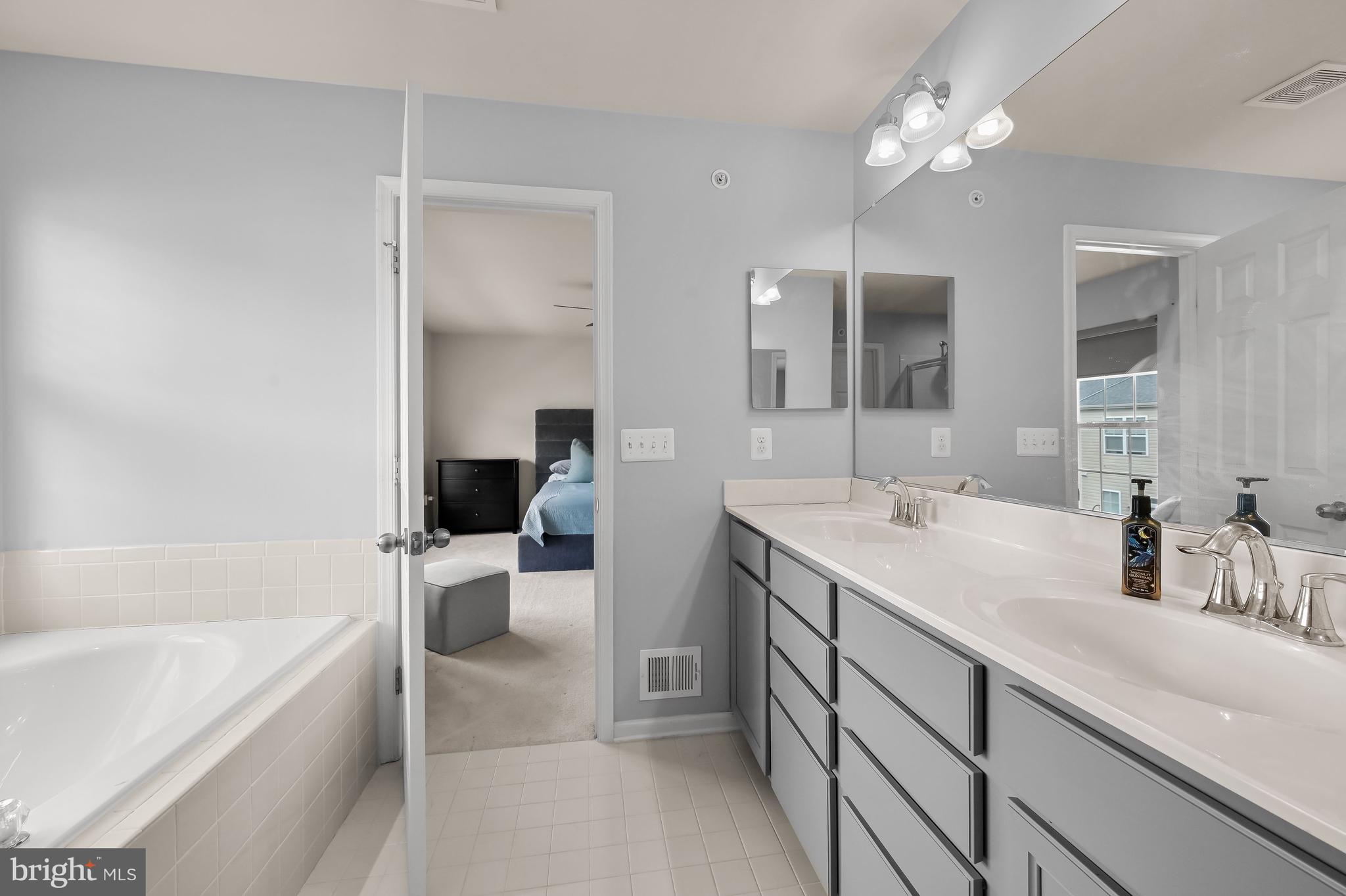 3515 Doc Berlin Drive Silver Spring, MD 20906 - Photo 21 of 49 a bathroom with a tub sink and a mirror