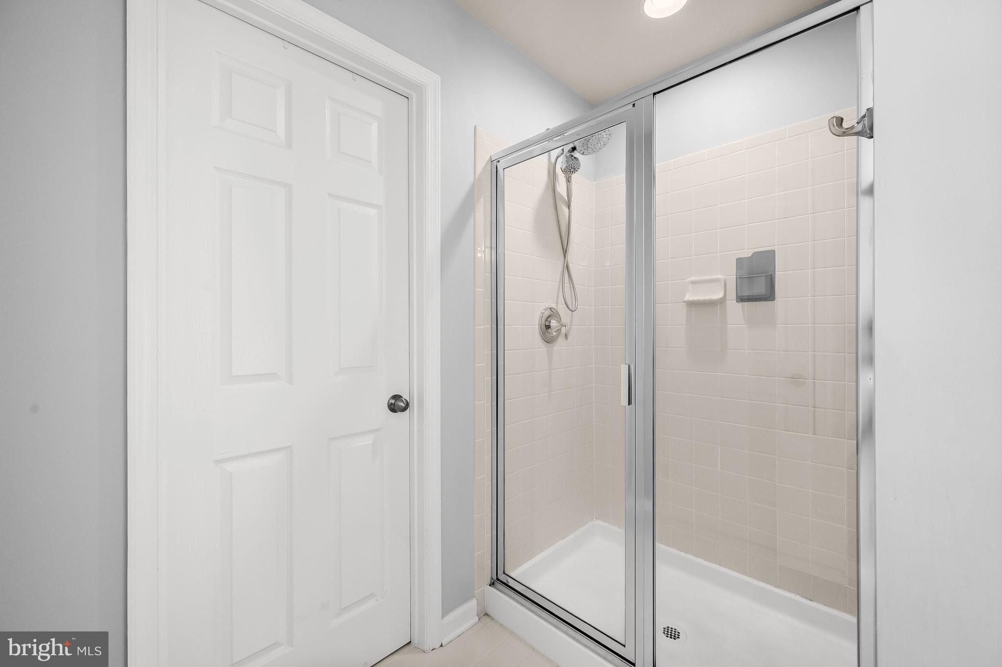 3515 Doc Berlin Drive Silver Spring, MD 20906 - Photo 22 of 49 a bathroom with a glass shower door