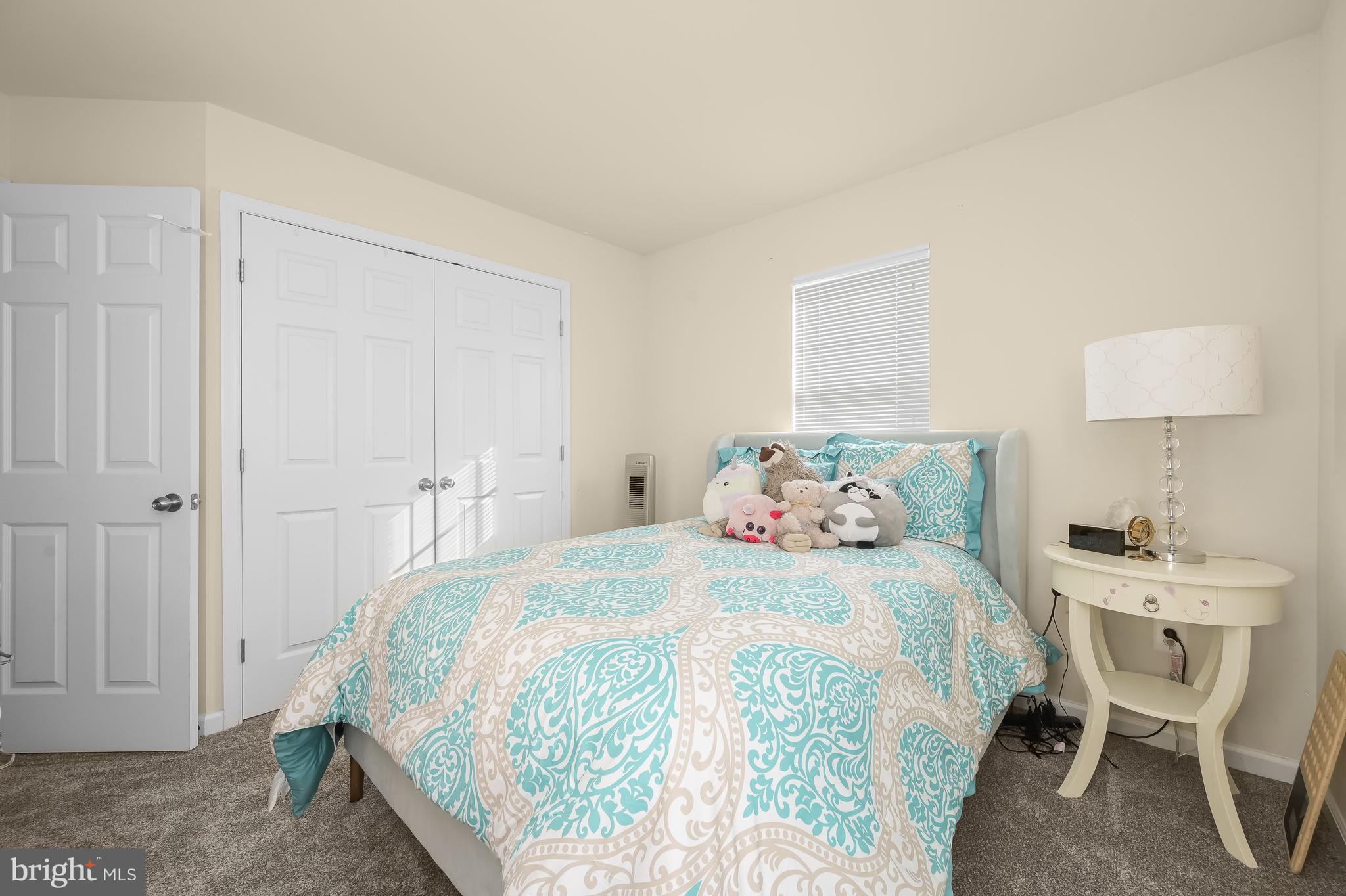 3515 Doc Berlin Drive Silver Spring, MD 20906 - Photo 27 of 49 a bedroom with a bed and a table in it