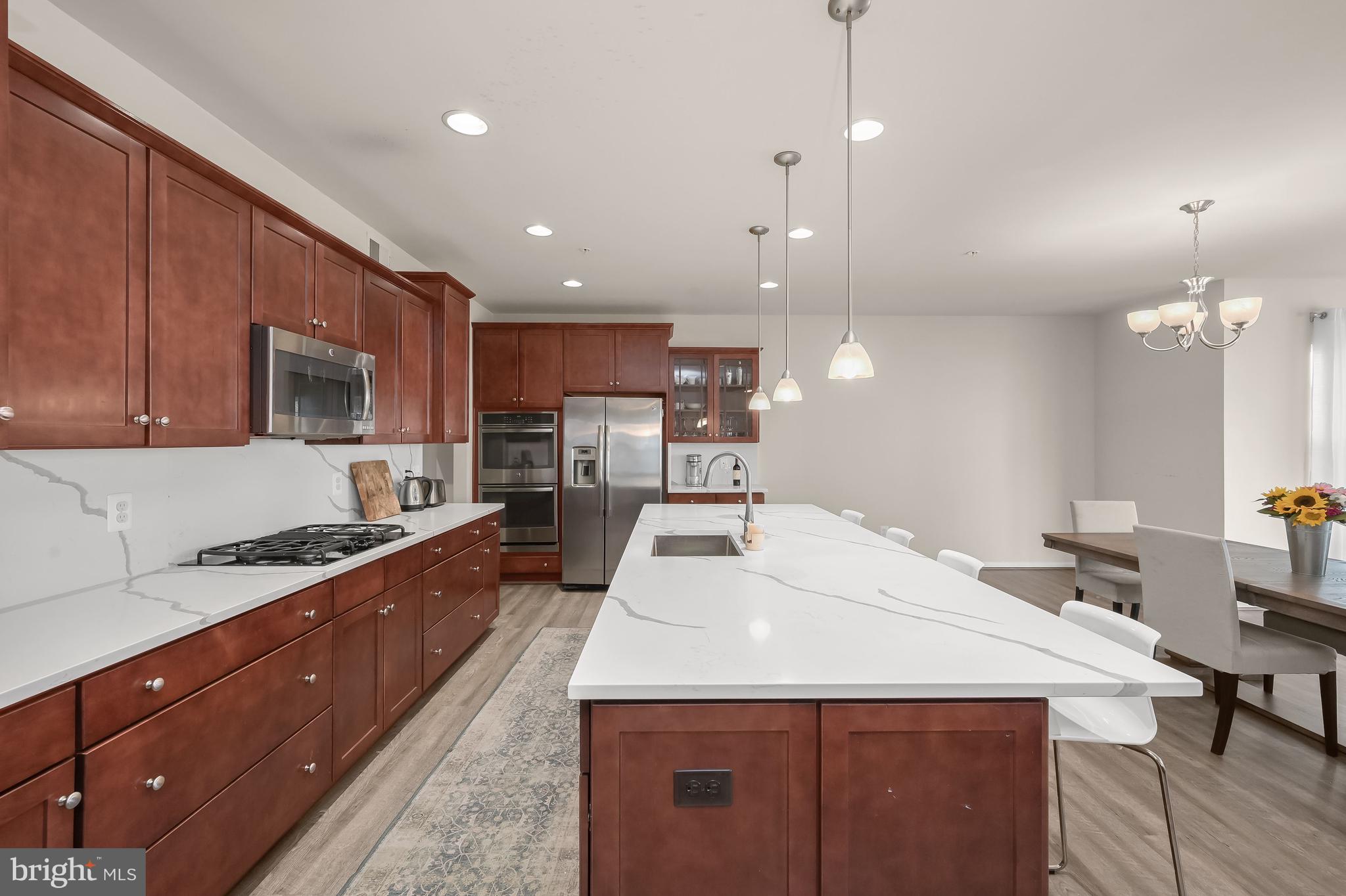 3515 Doc Berlin Drive Silver Spring, MD 20906 - Photo 3 of 49 a kitchen with stainless steel appliances kitchen island granite countertop a sink stove and cabinets