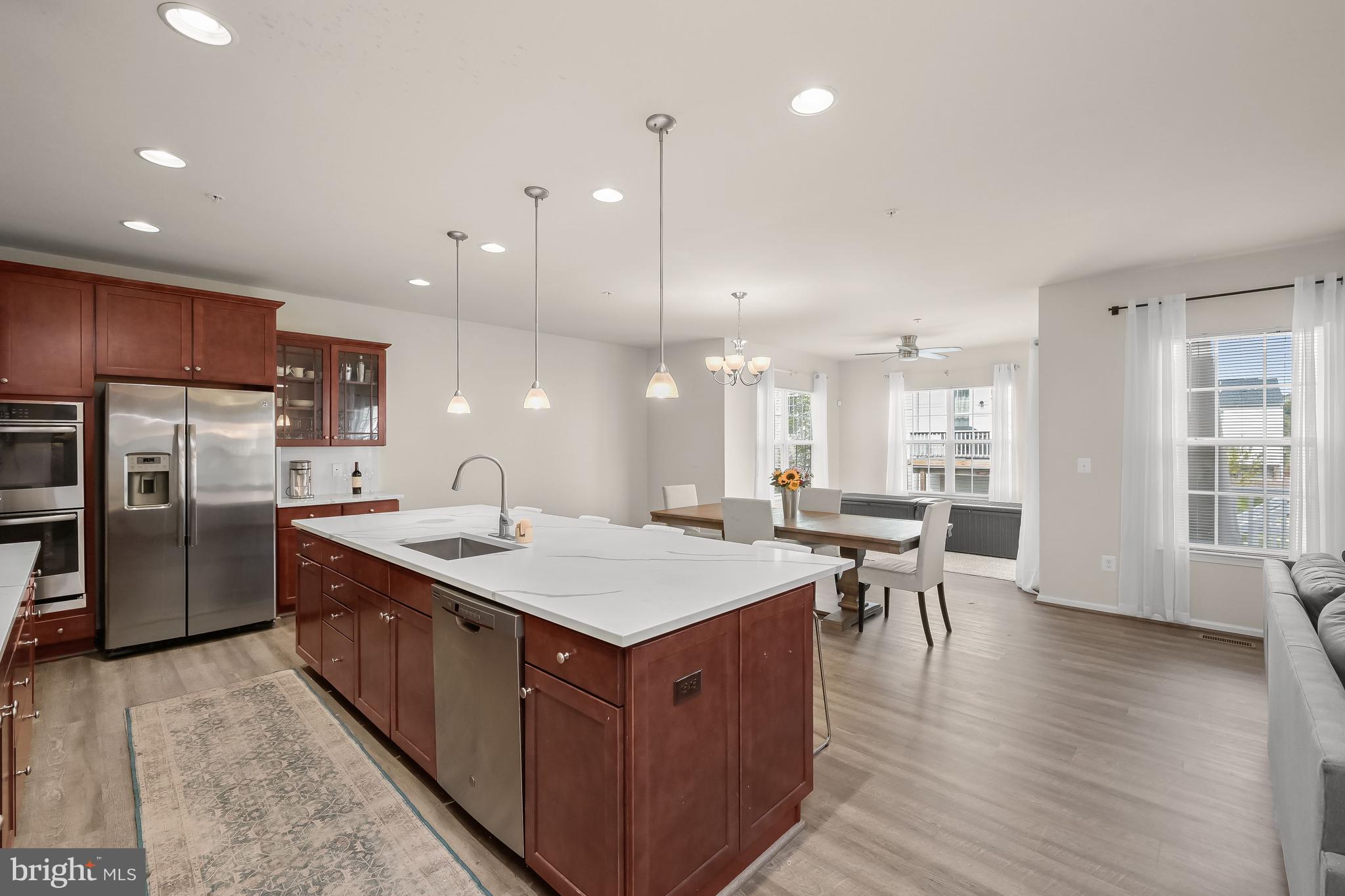 3515 Doc Berlin Drive Silver Spring, MD 20906 - Photo 4 of 49 a large kitchen with kitchen island a sink a stove a dining table and chairs