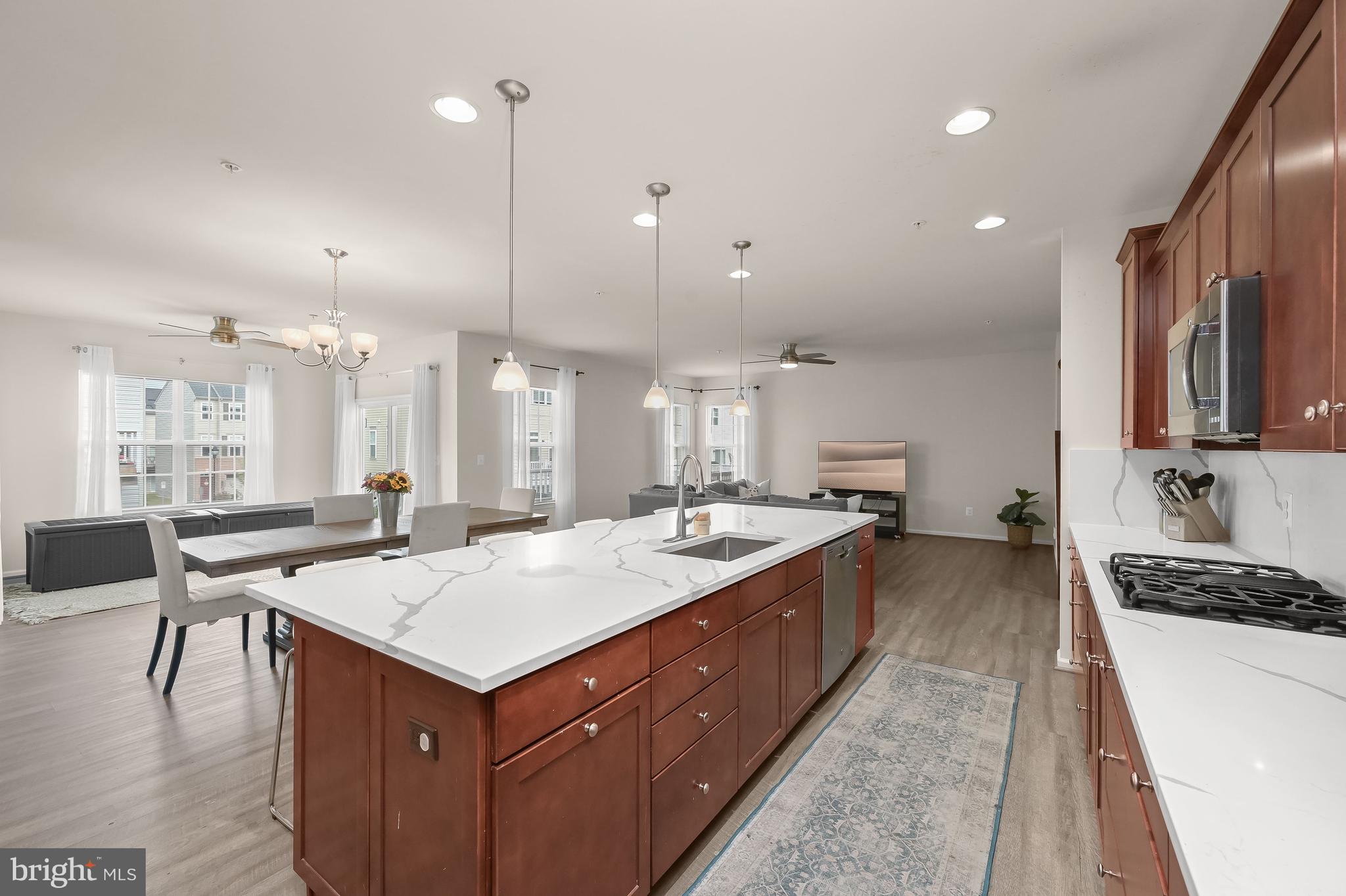 3515 Doc Berlin Drive Silver Spring, MD 20906 - Photo 5 of 49 a large kitchen with kitchen island a stove a sink a table and chairs