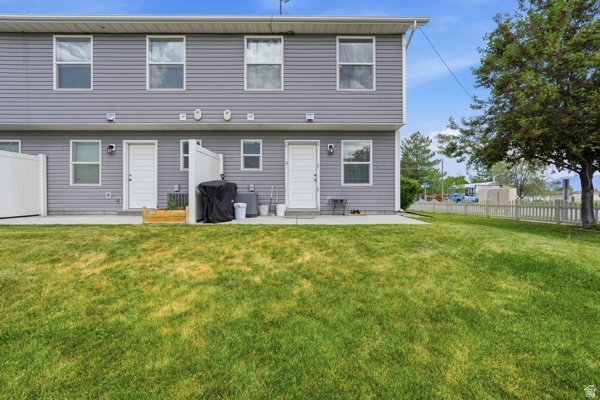 391 South 440th Street West Preston, ID 83263 - Photo 3 of 28 Expansive green lawn extending from a concrete patio