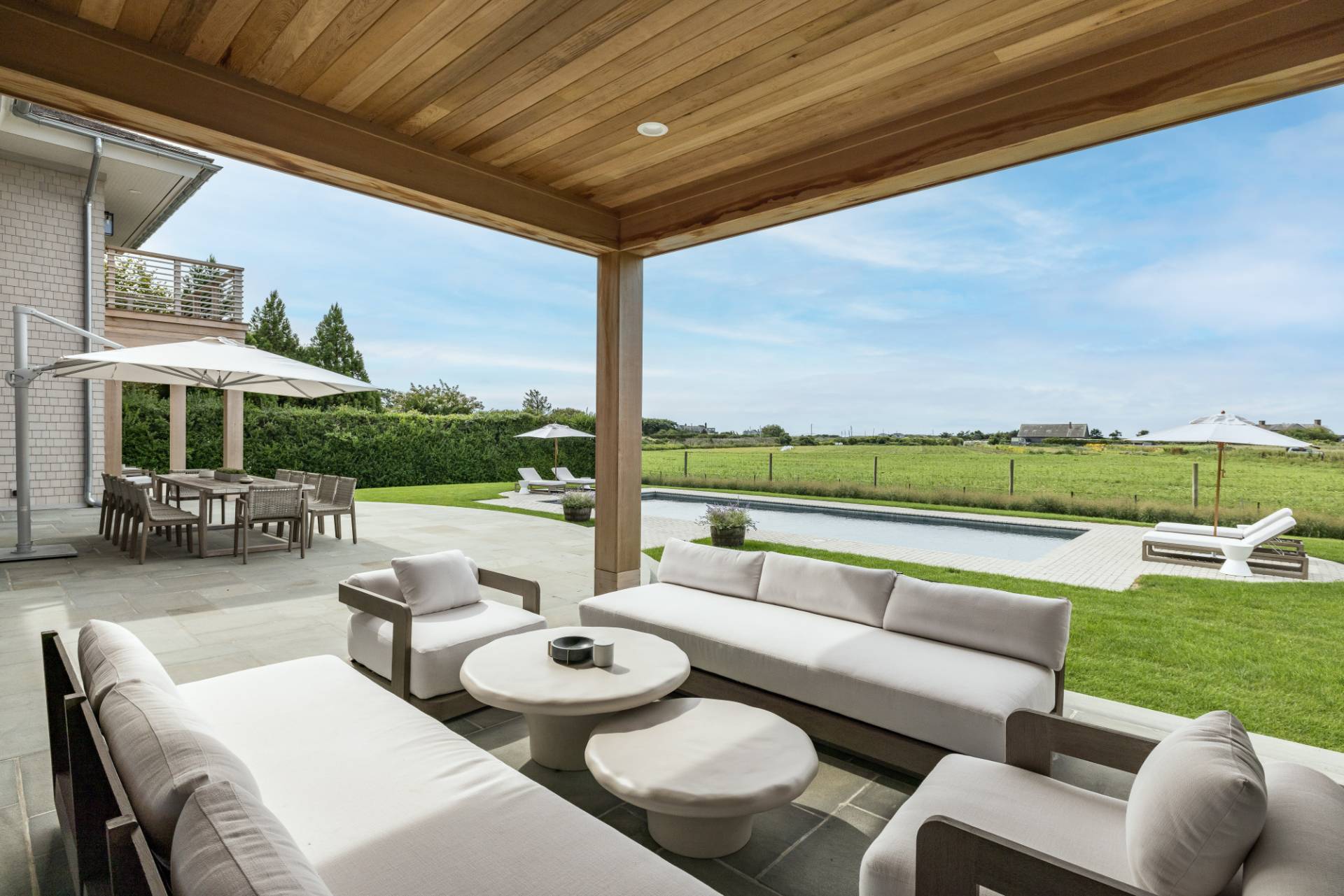 Undisclosed Address Sagaponack, NY 11962 - Photo 34 of 40 a balcony with furniture and a garden