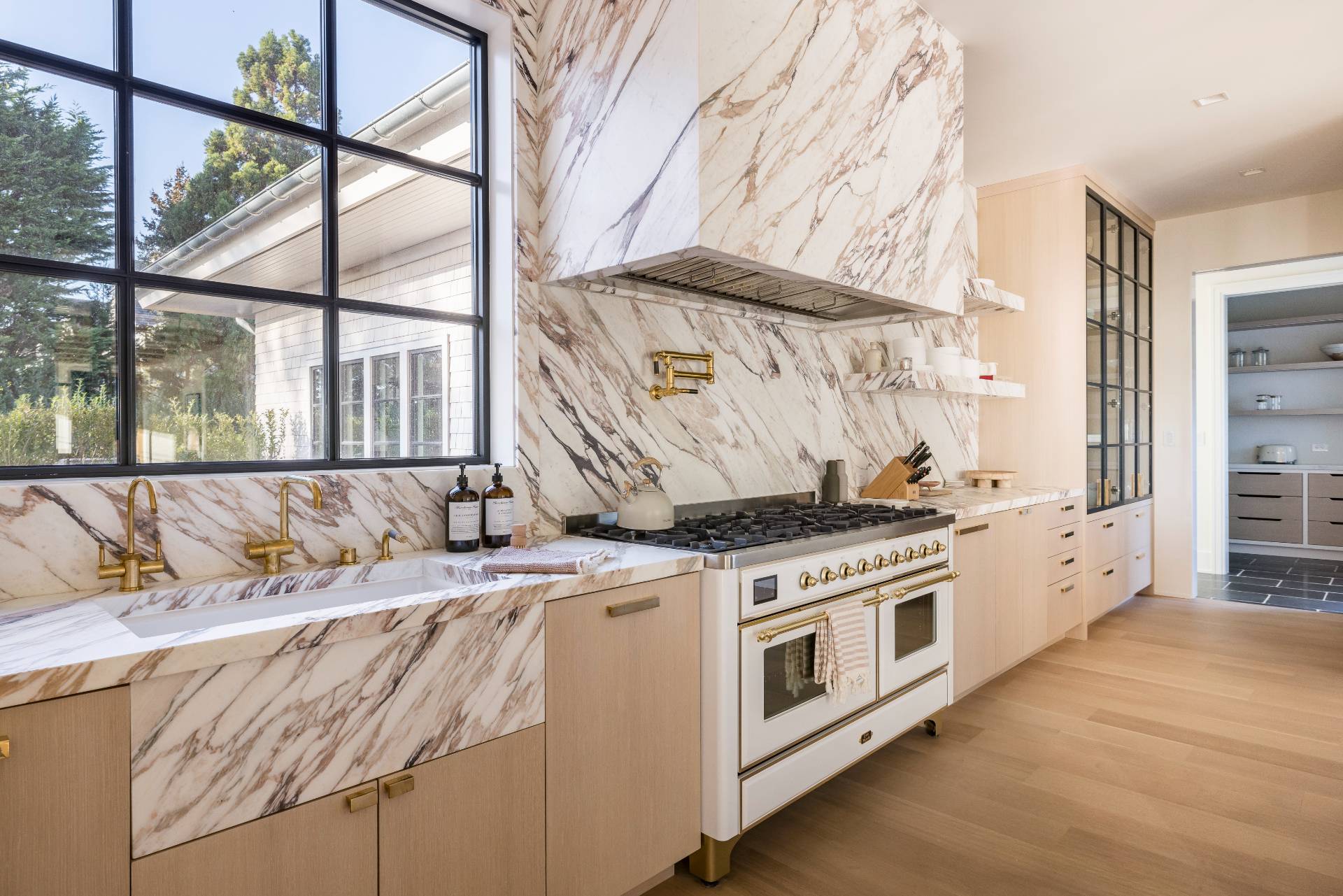 Undisclosed Address Sagaponack, NY 11962 - Photo 10 of 40 a kitchen with a stove and a white wooden cabinets