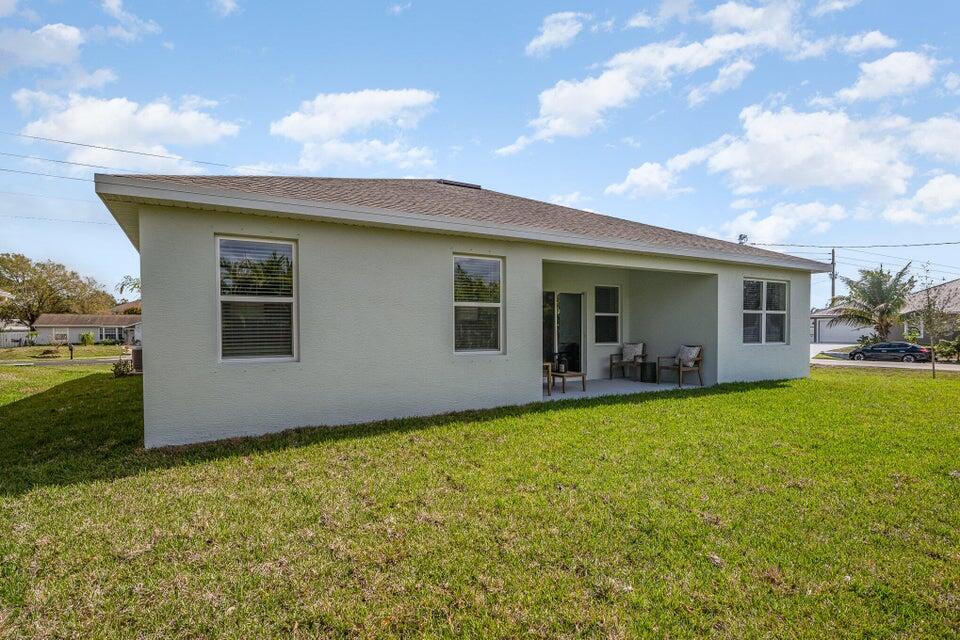 2372 Southwest Lejune Street Port St. Lucie, FL 34953 - Photo 27 of 35 a view of house with backyard and garden
