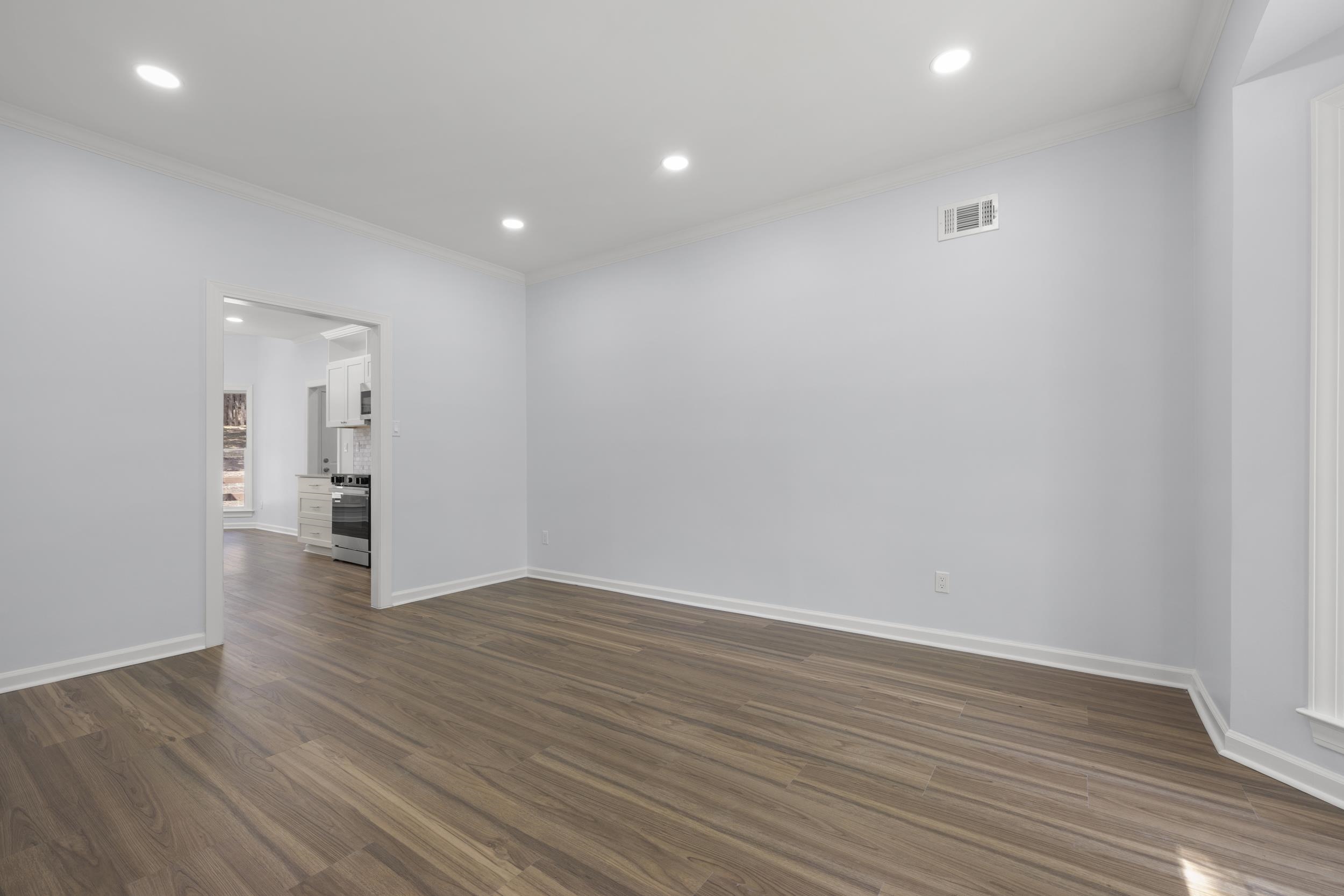 486 Brook Ridge Circle Memphis, TN 38018 - Photo 9 of 40 Unfurnished room with crown molding, recessed lighting, and dark wood-style flooring