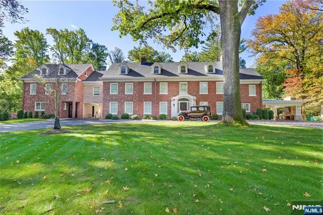 a front view of a house with a yard table and chairs
